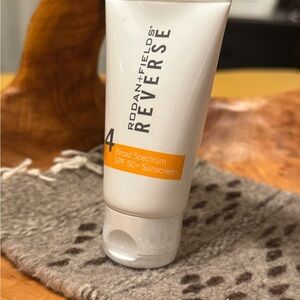 Rodan + Fields REVERSE SPF 50+ Sunscreen - White and Orange Tube
